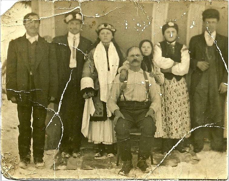 An installation with paintings, textiles and ladders is shown as a physical collage. The space they sit within is white and lit from above.