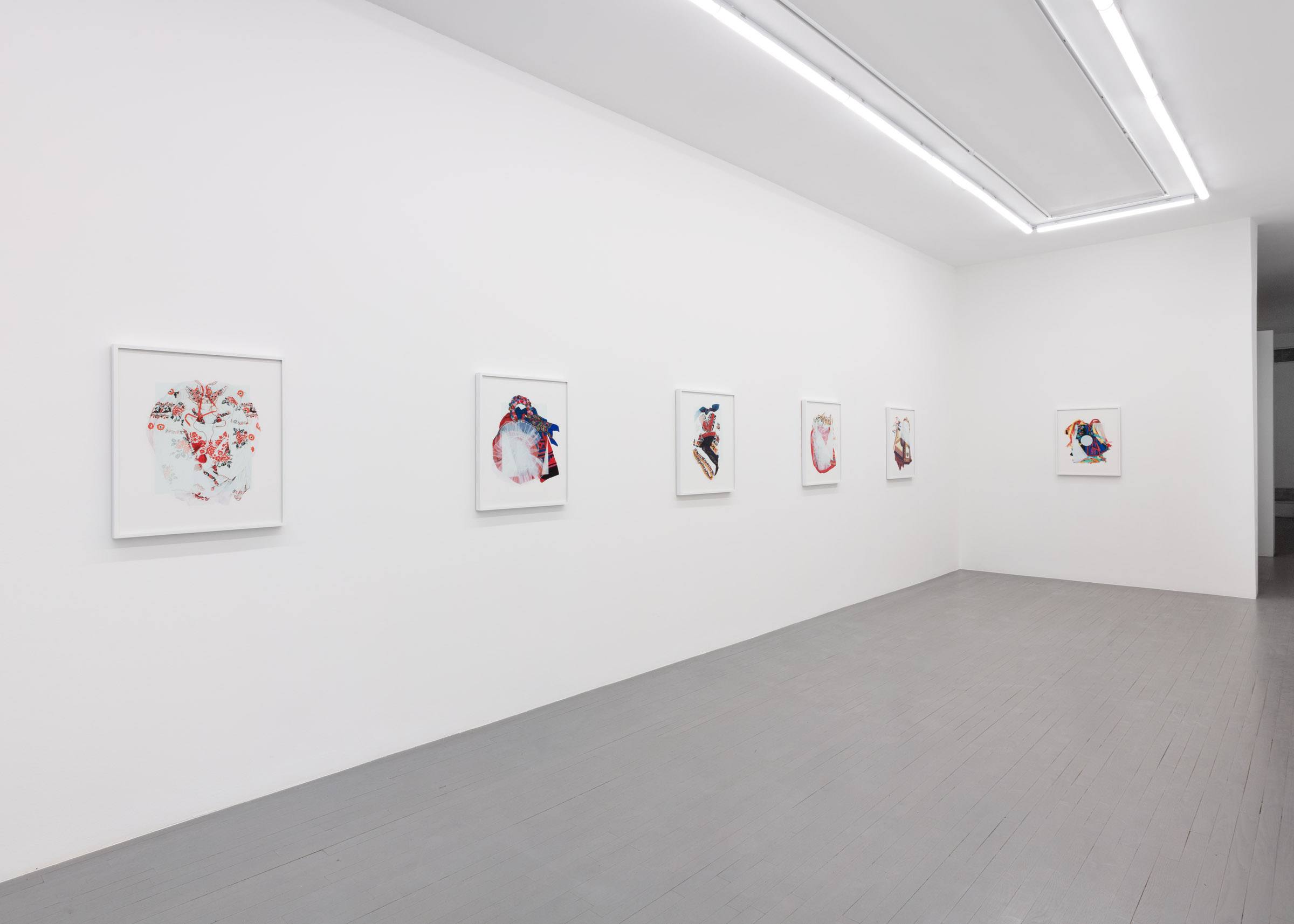 A Carpathian region Ukrainian dance costume is compressed beneath a sheet of glass.